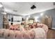 A beautifully decorated bedroom features a decorative pink couch, plush bedding, and a large projector screen at 70 Lake Charles Xing, Covington, GA 30016