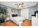 Cozy bedroom featuring a ceiling fan, wood floors, and neutral decor at 70 Lake Charles Xing, Covington, GA 30016