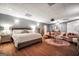 This open bedroom layout includes a lounge area, large bed, wood floors and ample lighting at 70 Lake Charles Xing, Covington, GA 30016
