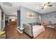 Nicely staged bedroom with hardwood floors, gray walls and decor, and a doorway to a kitchen area at 70 Lake Charles Xing, Covington, GA 30016