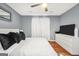 Spacious bedroom features wood floors, a ceiling fan, and neutral decor at 70 Lake Charles Xing, Covington, GA 30016