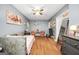 Charming bedroom with wood floors, ceiling fan, and gray walls adorned with eclectic modern decorations at 70 Lake Charles Xing, Covington, GA 30016