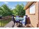 Charming outdoor deck with comfortable seating perfect for enjoying views of the lush backyard at 70 Lake Charles Xing, Covington, GA 30016