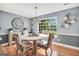 Elegant dining room with a large window overlooking the backyard at 70 Lake Charles Xing, Covington, GA 30016