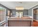Dining room features a table, chairs, bench, and a modern chandelier at 70 Lake Charles Xing, Covington, GA 30016