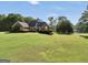 Brick home with well-kept lawn and view of the adjacent lake at 70 Lake Charles Xing, Covington, GA 30016