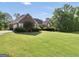 Lovely brick home with lush green lawn and manicured landscaping at 70 Lake Charles Xing, Covington, GA 30016
