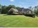 Beautiful brick home with a well-maintained lawn and traditional landscaping at 70 Lake Charles Xing, Covington, GA 30016