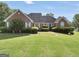 Lovely brick home featuring a beautifully maintained lawn and mature landscaping at 70 Lake Charles Xing, Covington, GA 30016