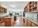 Bright, open-concept kitchen and dining area featuring wooden cabinets, marble countertops, and hardwood floors at 70 Lake Charles Xing, Covington, GA 30016