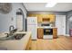 A cozy kitchen features wood cabinetry, updated appliances, and efficient layout with ample counter space at 70 Lake Charles Xing, Covington, GA 30016