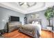 Comfortable main bedroom with hardwood floors, decorative ceiling, and contemporary furnishings at 70 Lake Charles Xing, Covington, GA 30016