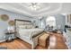 Spacious main bedroom with tray ceilings, wood floors, sitting area, and large windows at 70 Lake Charles Xing, Covington, GA 30016
