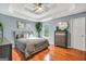 Spacious main bedroom with tray ceilings, wood floors, and modern decor at 70 Lake Charles Xing, Covington, GA 30016