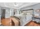 Bright main bedroom boasts a tray ceiling, wood floors, a comfortable sitting area, and decor at 70 Lake Charles Xing, Covington, GA 30016