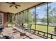 Relaxing screened patio features outdoor seating and peaceful views of the lawn and lake at 70 Lake Charles Xing, Covington, GA 30016