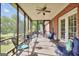 Comfortable screened patio with ample seating for relaxing and enjoying beautiful backyard views at 70 Lake Charles Xing, Covington, GA 30016