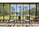 Inviting screened patio with comfortable seating and serene views of the lake and surrounding nature at 70 Lake Charles Xing, Covington, GA 30016
