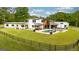 This modern home boasts a fenced yard, swimming pool, and outdoor entertainment areas at 159 Sims Rd, Tyrone, GA 30290