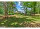 A large fenced backyard with mature trees surrounds this two-story, modern home at 159 Sims Rd, Tyrone, GA 30290