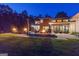 Backyard at dusk with pool, fire pits and home exterior at 159 Sims Rd, Tyrone, GA 30290