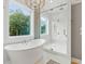 Bathroom boasts a large glass enclosed shower and a freestanding soaking tub with a scenic window view at 159 Sims Rd, Tyrone, GA 30290