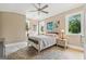 Comfortable bedroom featuring neutral tones, hardwood floors, modern ceiling fan, and natural light at 159 Sims Rd, Tyrone, GA 30290