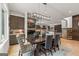 Elegant dining room features stylish lighting, a wine rack, and seating for six around a wood table at 159 Sims Rd, Tyrone, GA 30290
