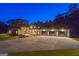 Expansive modern home with a three car garage and large driveway, beautifully lit at dusk at 159 Sims Rd, Tyrone, GA 30290