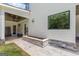 A patio with stone planter box sits outside of the white and stone modern home at 159 Sims Rd, Tyrone, GA 30290