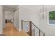 Second story hallway features hardwood floors, modern lighting, and entry to a bedroom at 159 Sims Rd, Tyrone, GA 30290