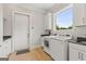 Modern laundry room featuring high-end washer and dryer, ample storage, and natural light at 159 Sims Rd, Tyrone, GA 30290