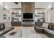 Contemporary living room with custom shelving, a cozy fireplace, and comfortable leather seating at 159 Sims Rd, Tyrone, GA 30290
