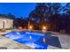 Backyard pool at night features luxurious lighting and elevated water features at 159 Sims Rd, Tyrone, GA 30290
