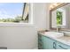 Stylish powder room featuring marble countertop, vessel sink, modern faucet, and a window with a view at 159 Sims Rd, Tyrone, GA 30290