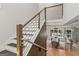 Modern staircase with wood and metal railings leading to a dining area with pool views at 159 Sims Rd, Tyrone, GA 30290