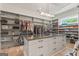Large walk-in closet with an island, custom shelves, and a designated space for shoes and accessories at 159 Sims Rd, Tyrone, GA 30290