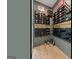 This wine room features custom racks to store wine bottles with stylish decor at 159 Sims Rd, Tyrone, GA 30290