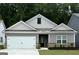 Charming single-story home featuring a two-car garage, a well-manicured lawn, and elegant landscaping at 435 Prescott Way, Villa Rica, GA 30180
