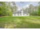 Expansive backyard with well-maintained lawn, perfect for outdoor activities and relaxation surrounded by mature trees at 2180 Briarwood Ct, Villa Rica, GA 30180