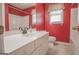 Bathroom boasts a white vanity, mirror, and a shower-tub combo at 2180 Briarwood Ct, Villa Rica, GA 30180