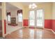 A dining area with hardwood floors, a fireplace, and double doors leading to the outside at 2180 Briarwood Ct, Villa Rica, GA 30180