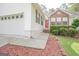 Inviting front entrance with red door, brick accents and meticulous landscaping along the front of the home at 2180 Briarwood Ct, Villa Rica, GA 30180