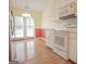 Bright kitchen features white cabinetry, modern appliances, and hardwood floors with an adjacent eating area and natural light at 2180 Briarwood Ct, Villa Rica, GA 30180