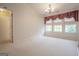 Bright living room with plush carpeting, decorative window treatments, and elegant chandelier create a welcoming space at 2180 Briarwood Ct, Villa Rica, GA 30180
