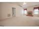Bright living room featuring a cozy brick fireplace, vaulted ceiling, and large windows for natural lighting at 2180 Briarwood Ct, Villa Rica, GA 30180