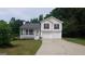Charming two-story home with a two car garage, covered porch, and well-maintained lawn at 2477 Briar Valley Way, Dacula, GA 30019