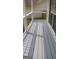 An inviting front porch with gray wood planks and elegant wrought iron railings at 2477 Briar Valley Way, Dacula, GA 30019