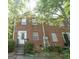 Brick townhouse with red shutters, white trim and a small front stoop surrounded by green foliage at 3191 Kingswood Gln, Decatur, GA 30034