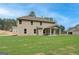 Wide backyard showcasing a home with a covered patio and ample lawn space at 100 Bre Dr, Fayetteville, GA 30214